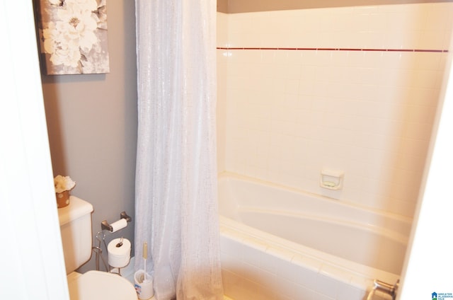 bathroom with toilet and shower / bathtub combination with curtain