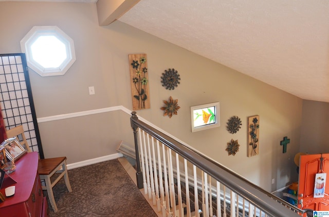 stairway featuring vaulted ceiling with beams and carpet