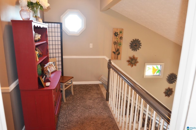 corridor with vaulted ceiling with beams