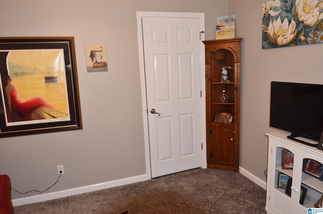 interior space featuring dark colored carpet