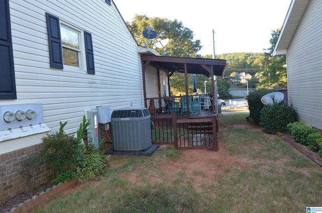 view of yard featuring central AC and a deck