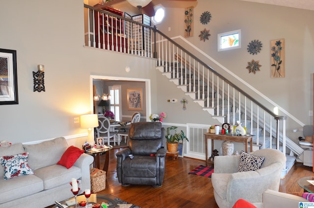 living room with hardwood / wood-style flooring and high vaulted ceiling