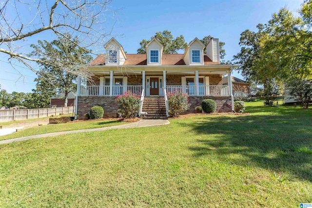 cape cod house with covered porch and a front yard