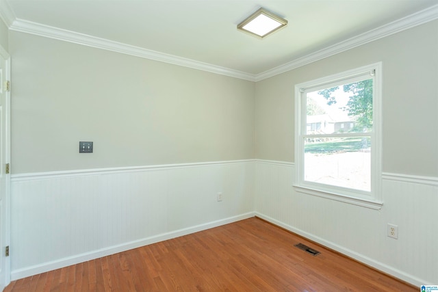 empty room featuring crown molding and hardwood / wood-style floors