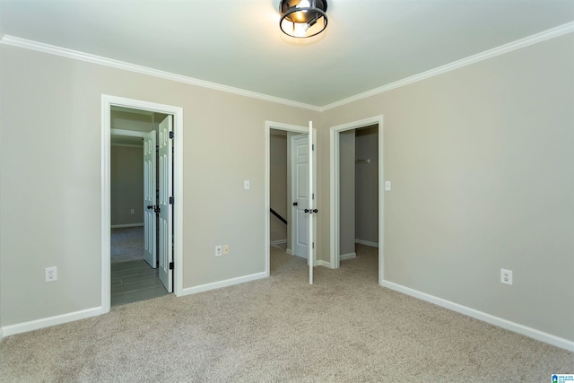 unfurnished bedroom featuring light carpet and crown molding