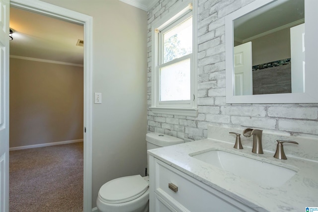 bathroom featuring crown molding, toilet, and vanity