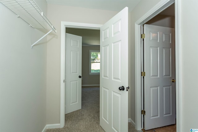 hallway featuring light carpet