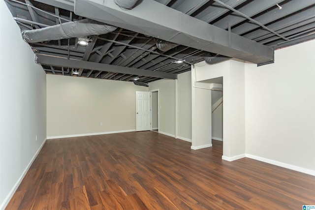 basement with dark hardwood / wood-style floors