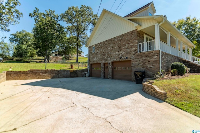 view of home's exterior featuring a garage and a yard