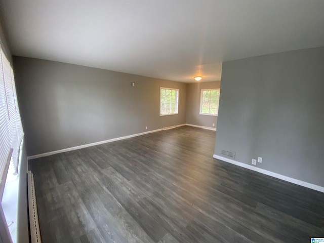 empty room featuring dark wood-type flooring