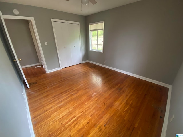 unfurnished bedroom with wood-type flooring and ceiling fan