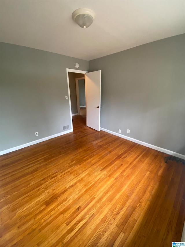 empty room with wood-type flooring