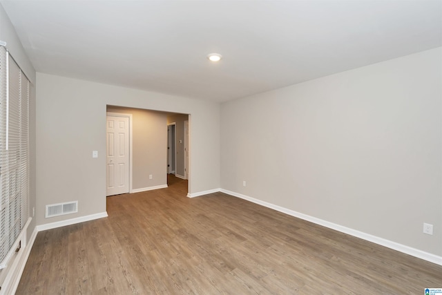 unfurnished room with wood-type flooring