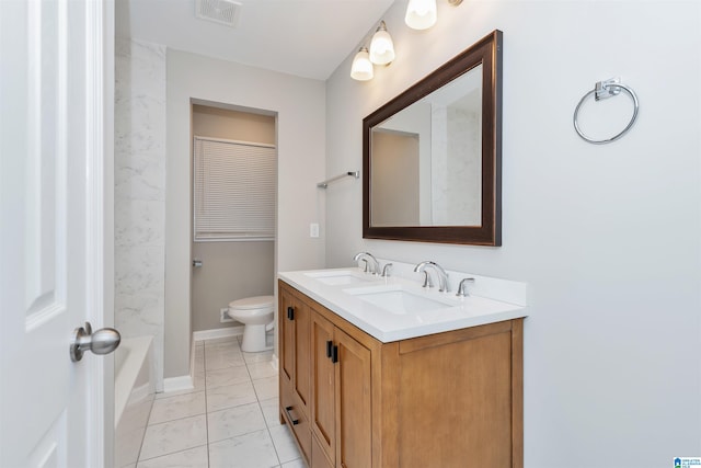 bathroom featuring tile patterned floors, vanity, and toilet