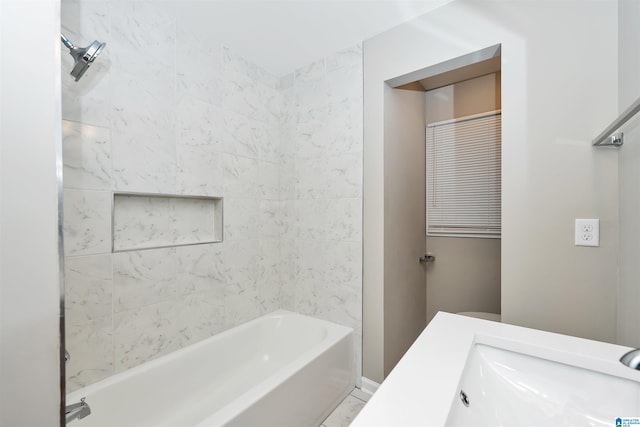 bathroom with vanity and tiled shower / bath