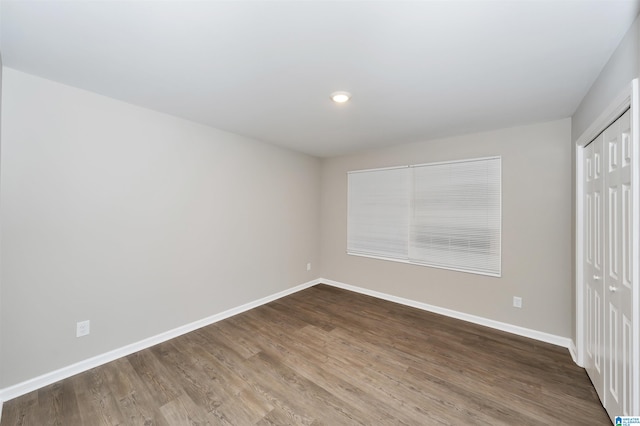 unfurnished bedroom featuring hardwood / wood-style floors and a closet