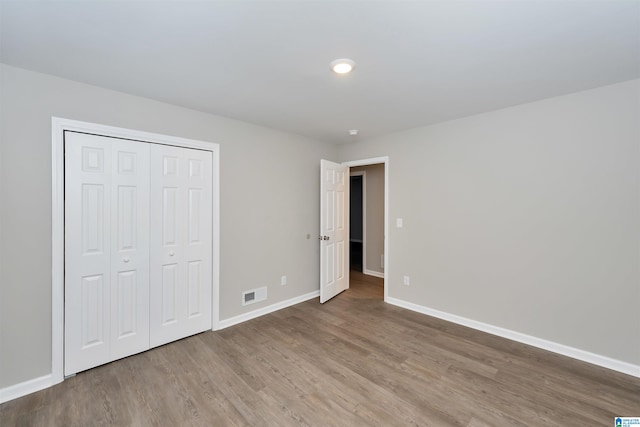 unfurnished bedroom with a closet and light hardwood / wood-style flooring