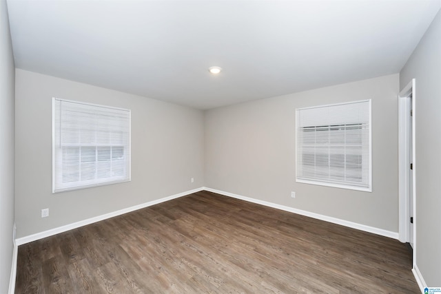 spare room featuring dark hardwood / wood-style flooring