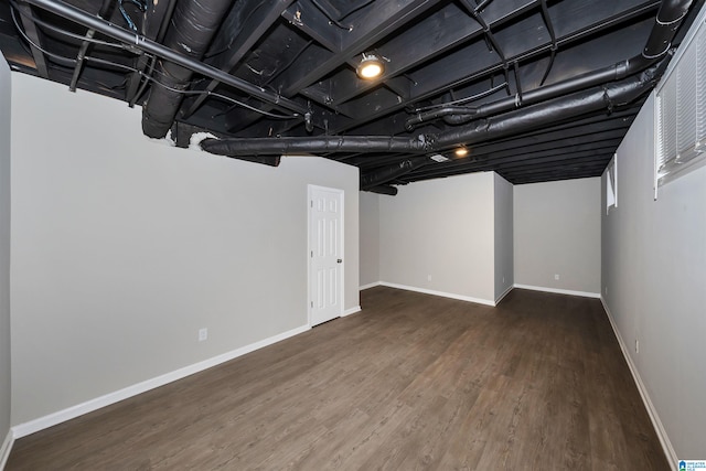 basement featuring dark hardwood / wood-style flooring