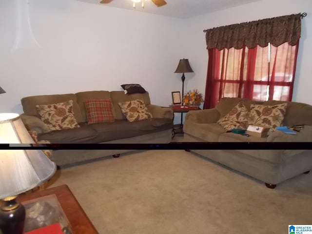 living room with ceiling fan and carpet flooring