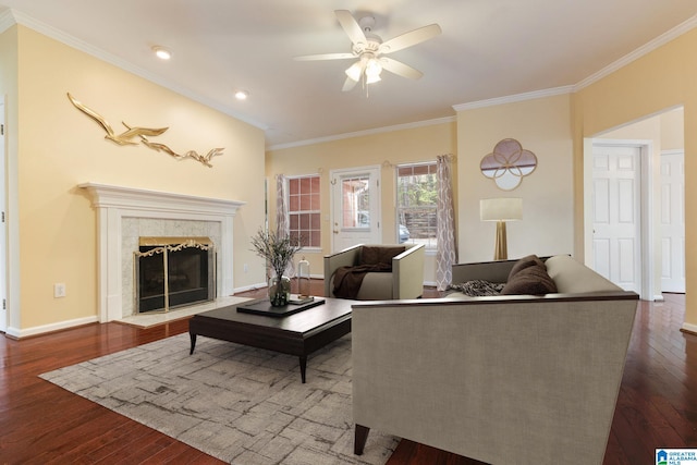 living room featuring a fireplace, wood-type flooring, ornamental molding, and ceiling fan