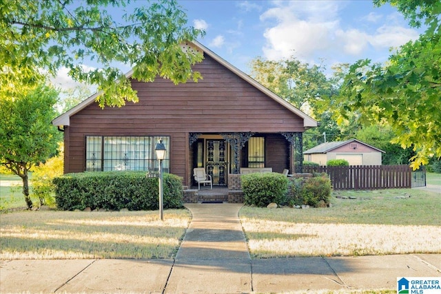 bungalow-style home featuring a porch and a front lawn