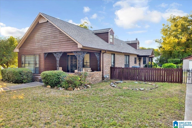 view of front of house featuring covered porch and a front lawn