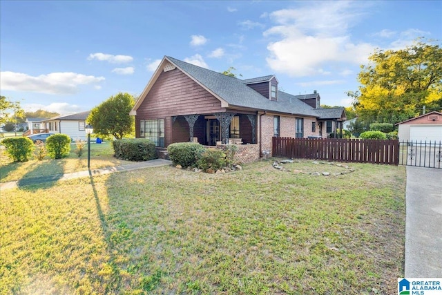 view of front of home featuring a front yard, an outdoor structure, and a garage