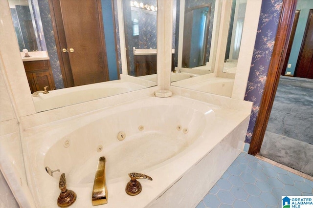 bathroom with vanity, tile patterned floors, and a tub to relax in