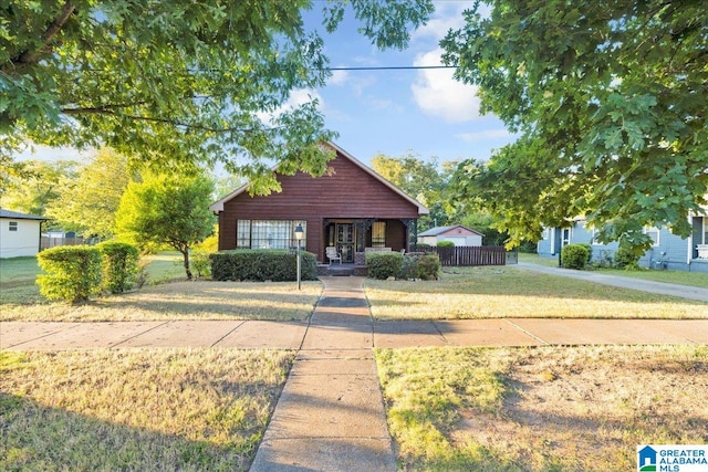 view of front of home with a porch and a front lawn