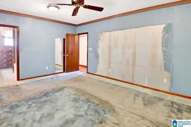 carpeted spare room featuring ceiling fan and crown molding