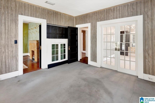 unfurnished bedroom featuring multiple closets, ornamental molding, baseboards, and ceiling fan