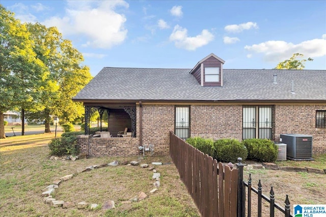 view of front facade featuring central air condition unit, a patio area, and a front lawn