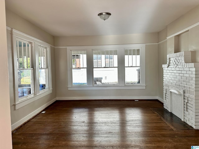 unfurnished living room featuring dark hardwood / wood-style floors and a fireplace