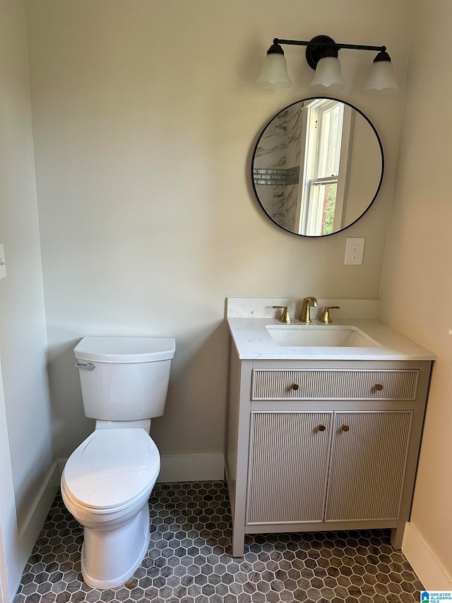 bathroom featuring tile patterned floors, vanity, and toilet