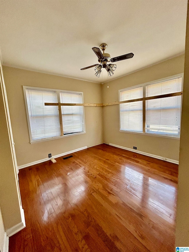 spare room with ceiling fan and hardwood / wood-style floors