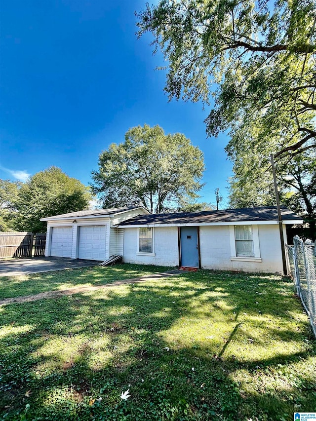 ranch-style home with a front yard and a garage