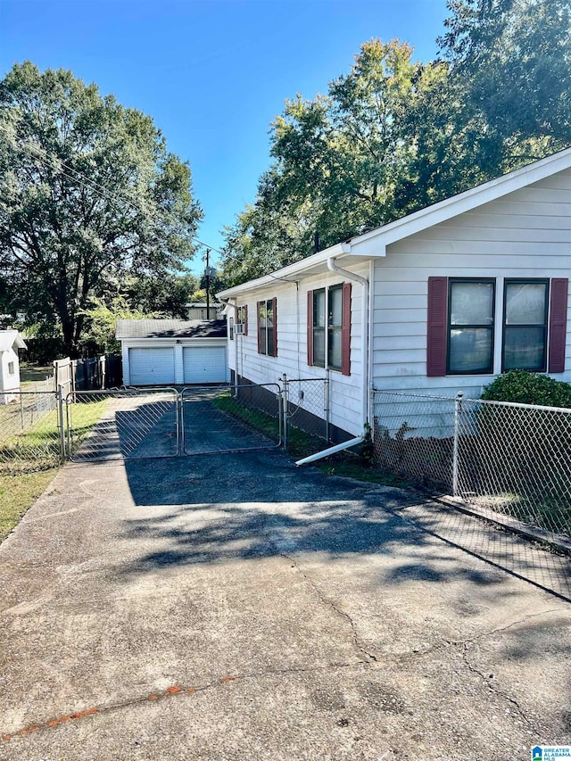 view of front of property featuring an outbuilding and a garage