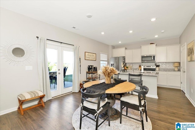 dining space with french doors, dark wood-type flooring, and sink