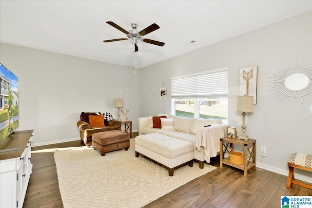 living area featuring dark hardwood / wood-style flooring and ceiling fan