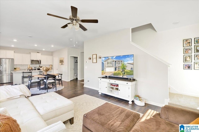 living room with ceiling fan and dark hardwood / wood-style floors