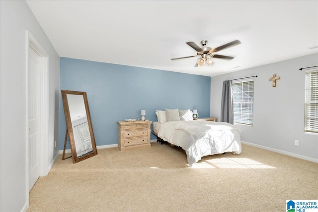 bedroom featuring ceiling fan and light carpet