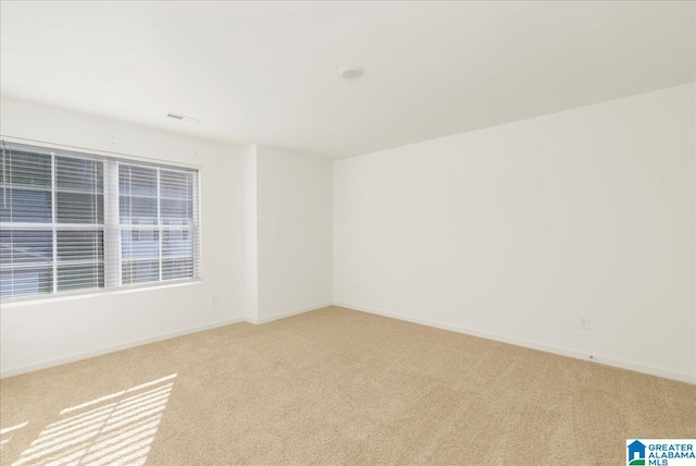 empty room with light colored carpet