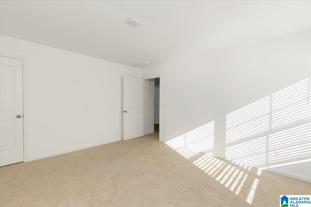 spare room with light colored carpet