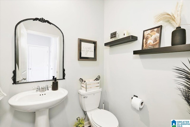 bathroom featuring toilet and sink