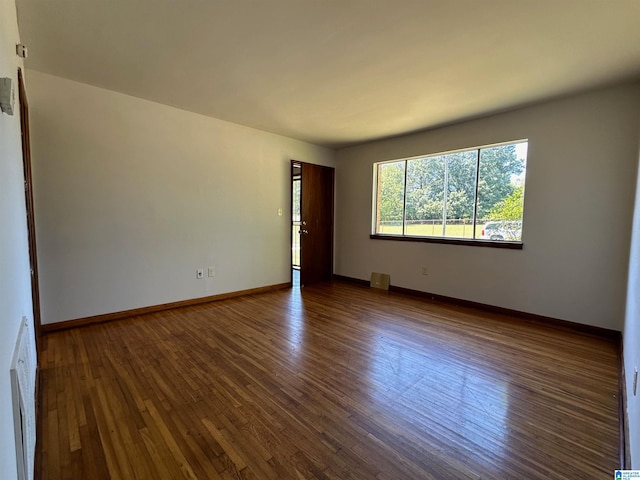 unfurnished room featuring dark hardwood / wood-style floors