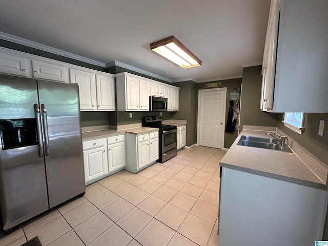 kitchen with ornamental molding, sink, white cabinets, light tile patterned floors, and appliances with stainless steel finishes