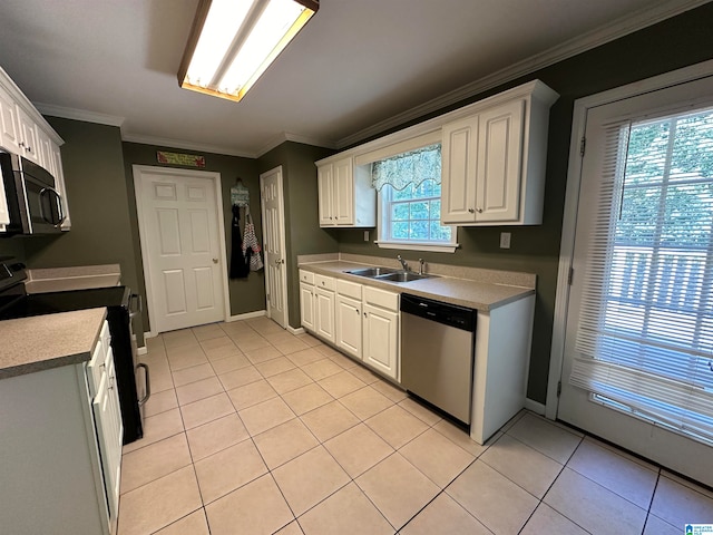 kitchen with a wealth of natural light, sink, appliances with stainless steel finishes, and white cabinetry