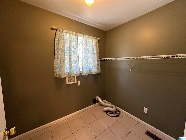 clothes washing area featuring tile patterned floors and hookup for a washing machine