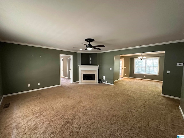 unfurnished living room featuring crown molding, light colored carpet, and ceiling fan with notable chandelier